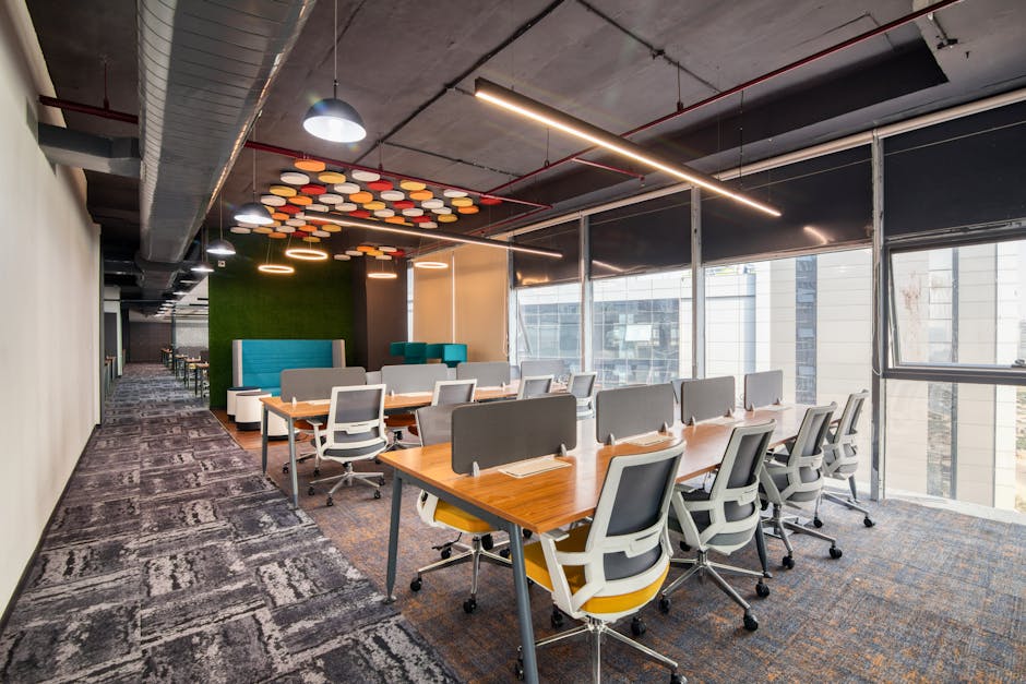 Spacious and modern open office interior with desks and chairs, ideal for business environments